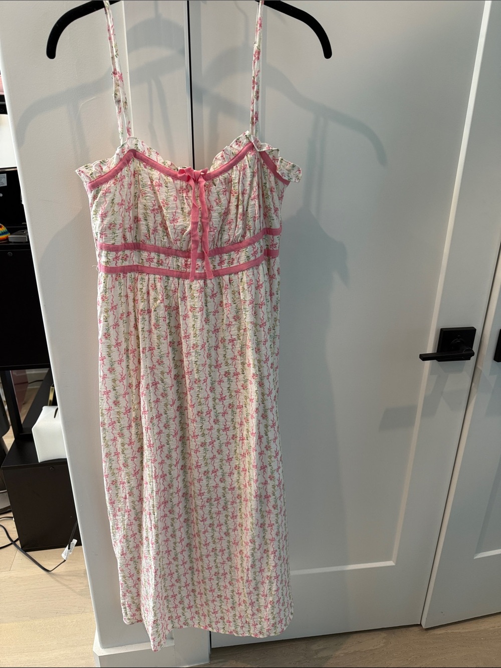 Super cute summer dress with floral and bow design.